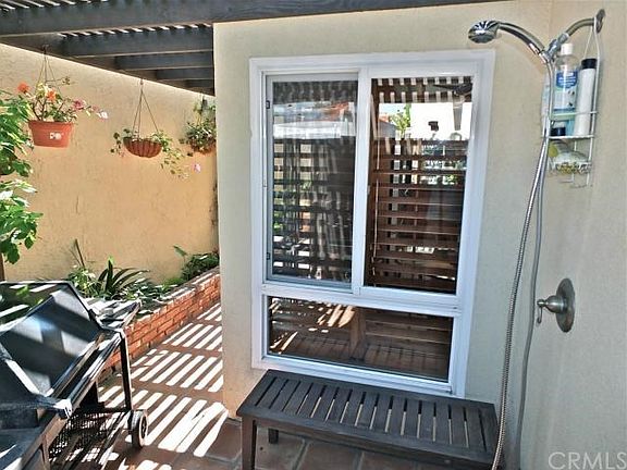 Towards the rear of the home, second patio complete with outdoor shower