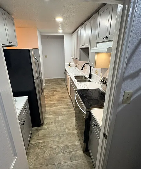 Kitchen with new cabinets, appliances, and new tiled floors