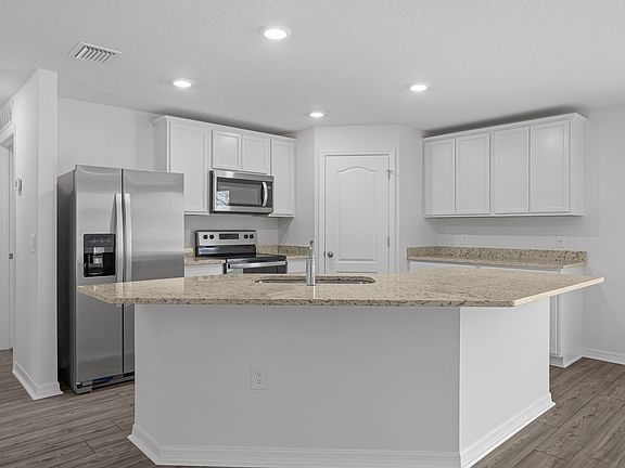 The kitchen comes chef-ready with stainless steel appliances