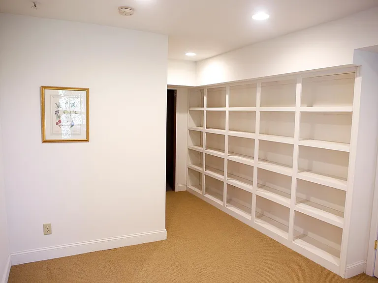 Basement (3rd) bedroom with lots of shelf space