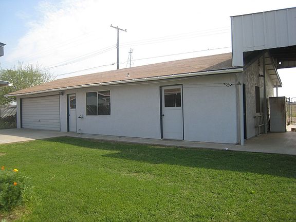 Backyard, and garge holds up to 4 cars with RV parking on the side