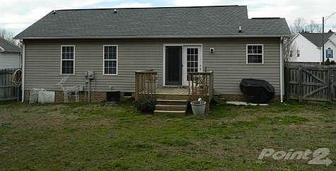 Rear of Home with Deck and Fenced Backyard