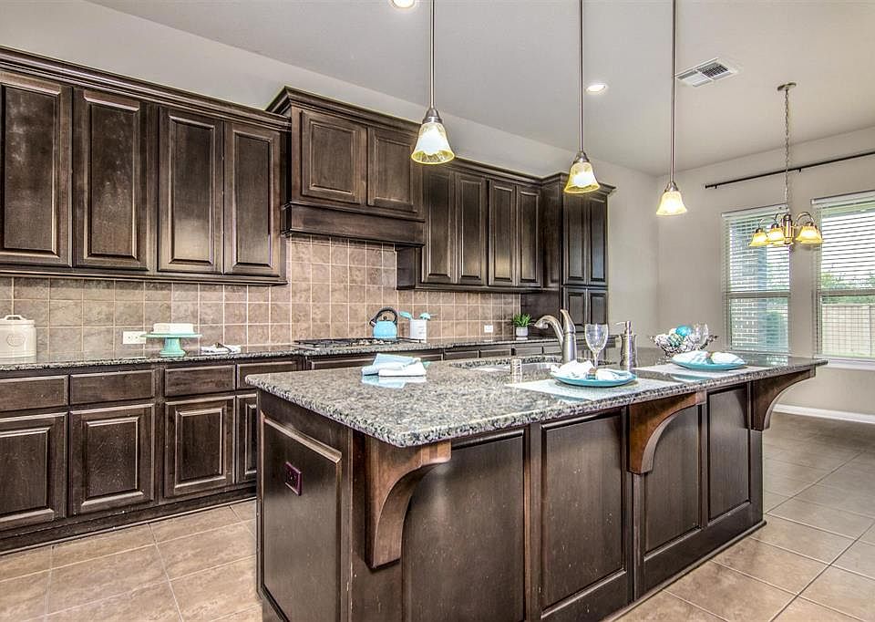 Kitchen has tile floors and tile back splash.