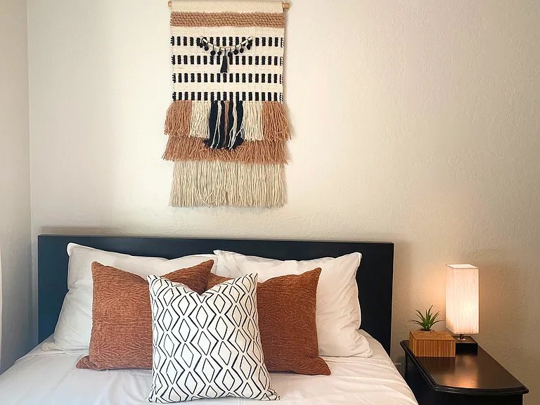Bedroom 3: Full-Sized bed with nightstand & table lamp.
