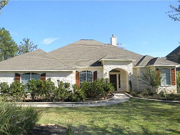 Fabulous Austin stone one story home in the gated Lake Conroe community of Grand Harbor.