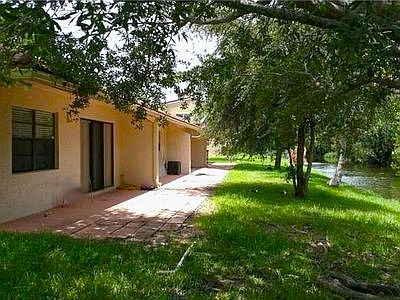 Your private patio with peaceful brook and mature trees