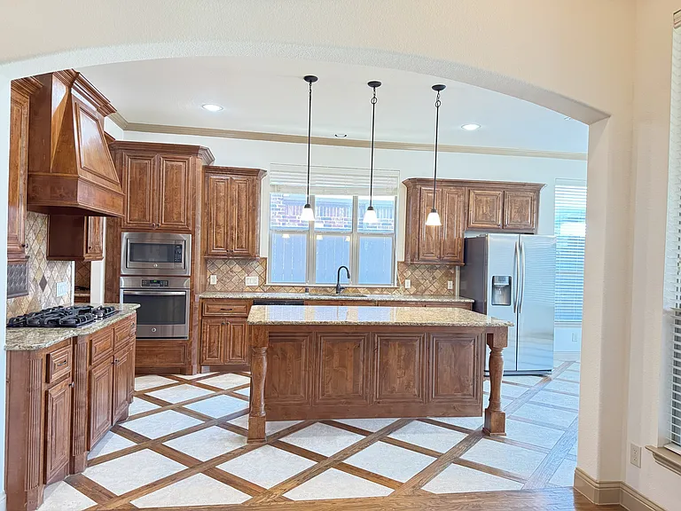 Kitchen with the island. Refriderator included. stainless steel appliances