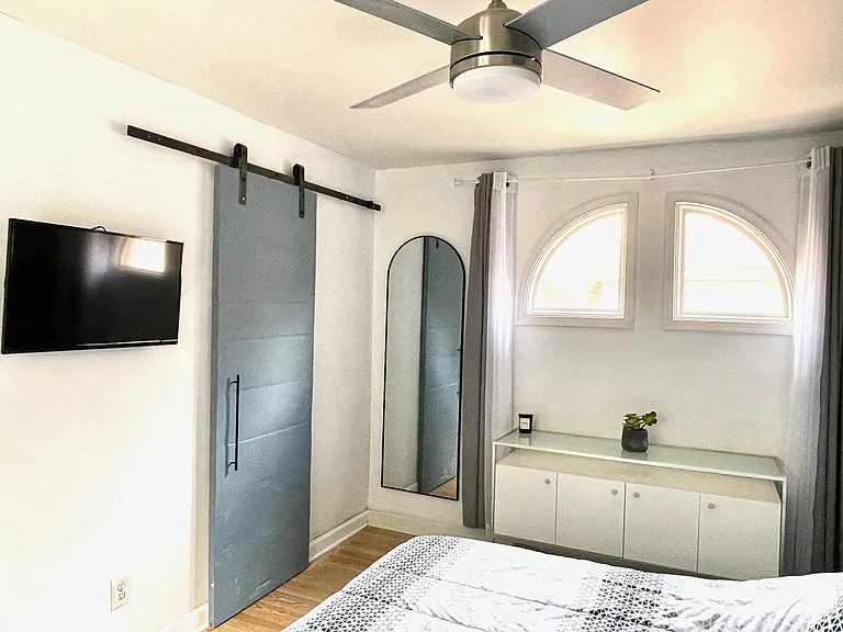 2nd bedroom corner shot with sliding door into the full bathroom