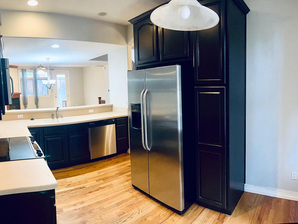 Kitchen with a deep cabinet to the right of the fridge.