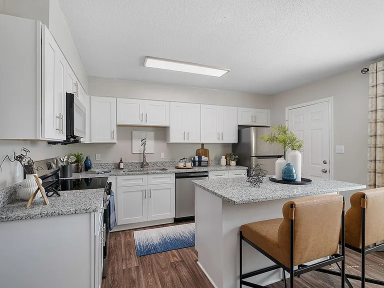 Kitchen with granite counters, stainless appliances, and modern cabinetry