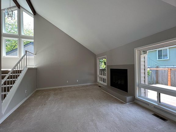 Spacious living room with vaulted ceiling and fireplace