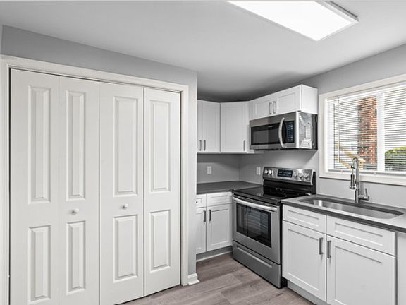 Kitchen, view 2, showing laundry closet.