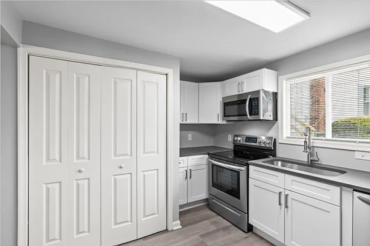 Kitchen, view 2, showing laundry closet.