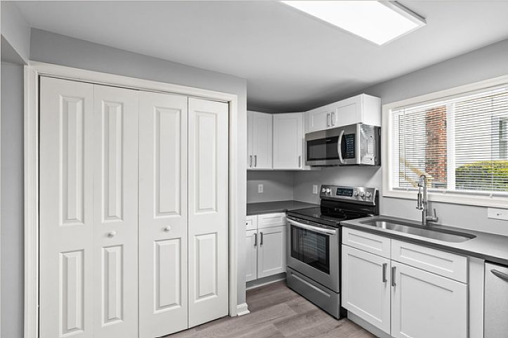Kitchen, view 2, showing laundry closet.