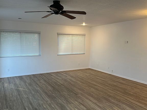 view of living area with new blinds and remote control fan