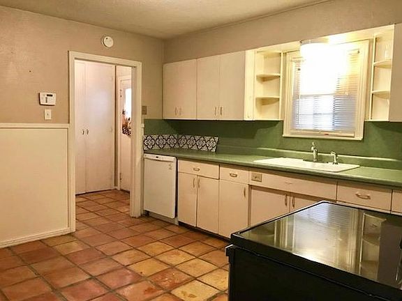 Large kitchen with lots of cabinets. Natural light and easy access to carport.