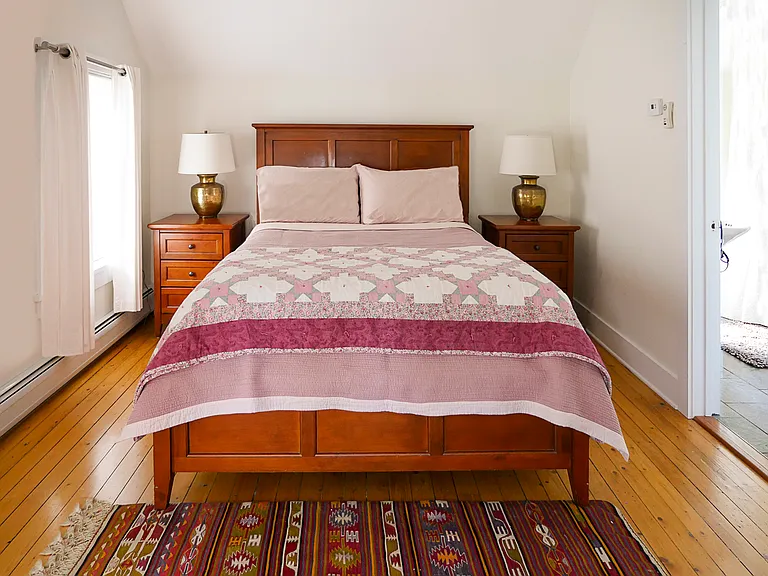 Master bedroom, includes quality all cotton sheets and all weather blankets. There is a closet (not shown in picture. Open door leads to the bathroom