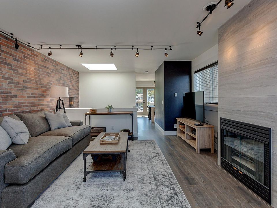 Living room with comfortable down couch and large 50" TV and gas fireplace