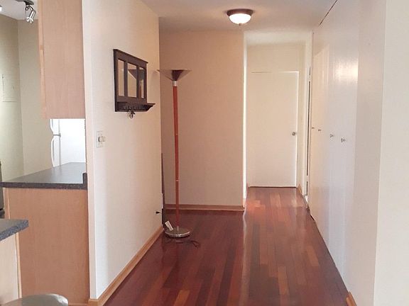 Main hallway - bedrooms to the back, kitchen and entry on the left, living room on the right.