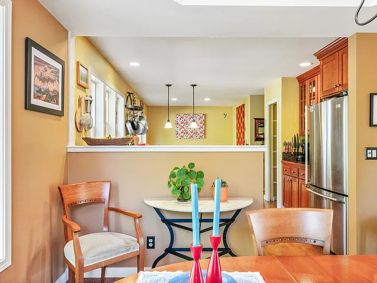 The kitchen flows off of the dining room, and looks out to the back yard from the large window over the sink.