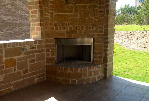 The Westfield VI Covered Patio with stone fireplace