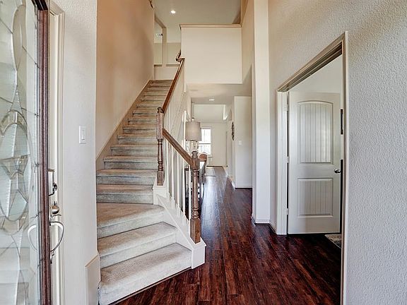 Step through the Lone Star inspired leaded glass and wood door to discover beautiful wood floors, soft neutral paint, soaring ceilings, and gorgeous natural light.