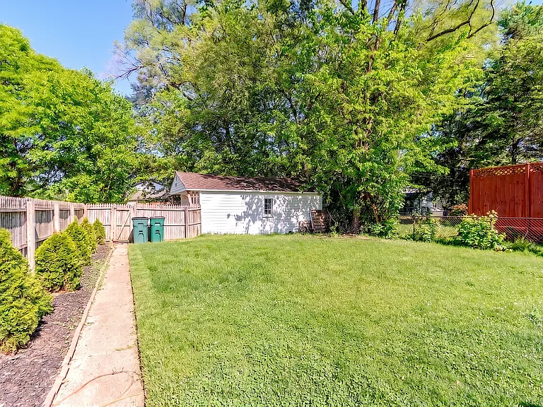 Spacious and fully fenced backyard featuring a detached garage, offering a fantastic outdoor space for relaxing or entertaining in this desirable Royal Oak neighborhood.