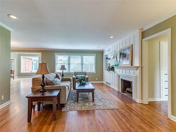 The main living area has built-in bookcases, and pretty fireplace. The windows are really beautiful in this house. You get a glimpse off to the left of one of the dining areas.