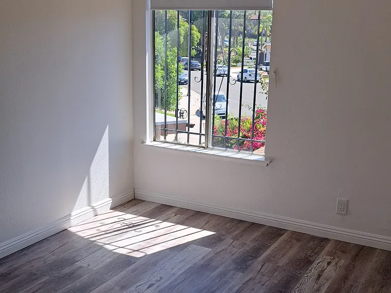 Upstairs Bedroom with ceiling fan and mirror doors