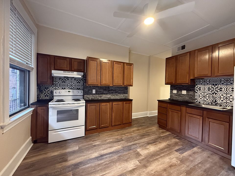 Spacious kitchen with ample counter space and patterned backsplash.