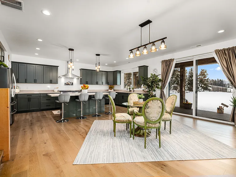 Sliding doors open to the outdoor patio, creating a seamless setting for morning coffee, sunset gatherings, and enjoying the peaceful Montana views.