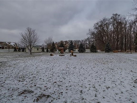 The professionally landscaped lot w/firepit offers room for pets & families to roam.