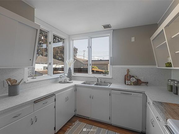 Kitchen with full sized refrigerator.