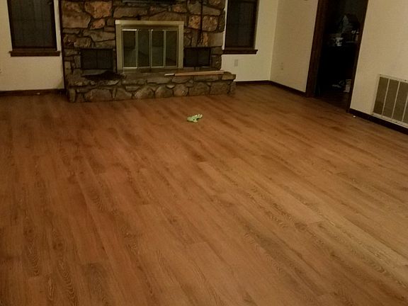 Living room with wood burning fireplace.