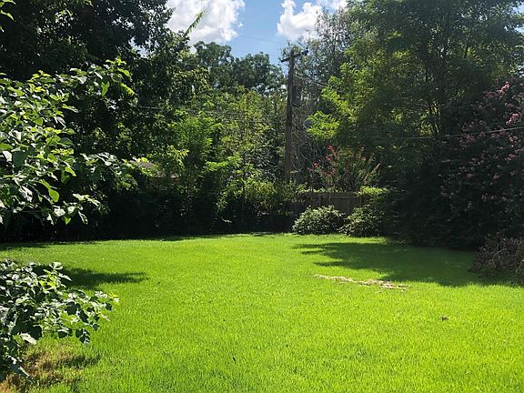 Quaint fenced in backyard. Small covered attached patio overlooks the yard.
