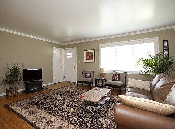 Formal living room boasts refinished hardwood