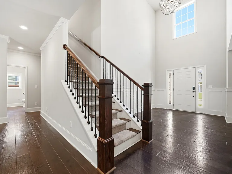 Bright & open foyer with plenty of room for a decorative table & bench