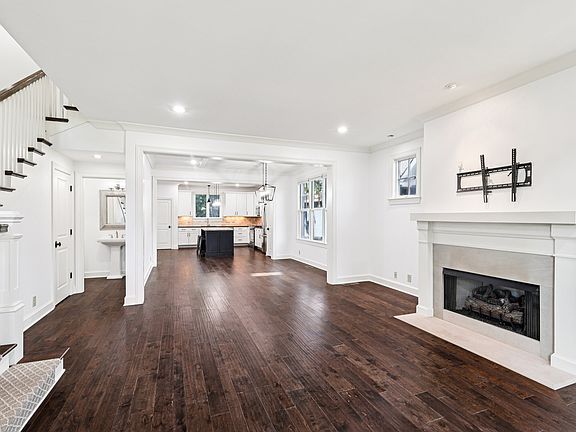 Open-concept living with hardwoods, fireplace, and seamless flow into a chef's kitchen_perfect for entertaining in 12 South!