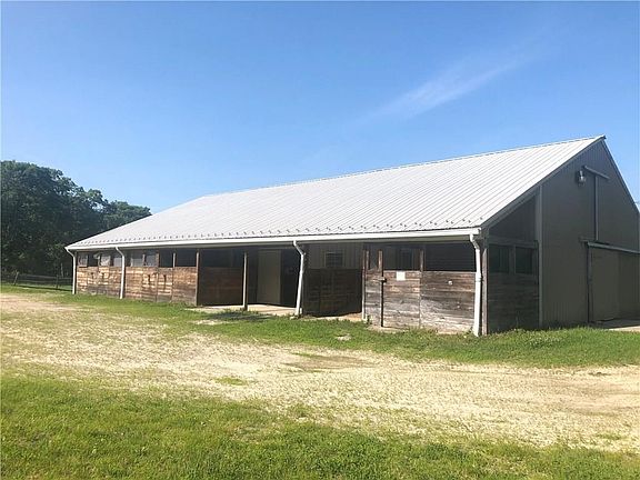 Right side of barn with overhang, wash stall, outdoor stalls attached