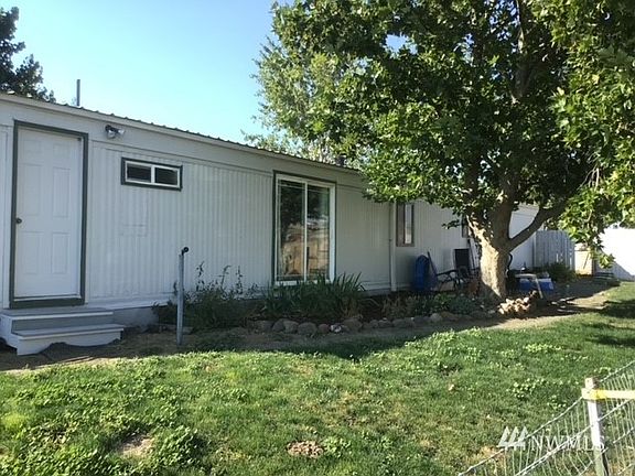 There is a tree-shaded back deck with views of the pasture.>