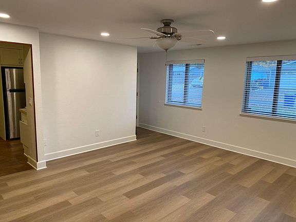 Entryway, living room, front windows, door to the kitchen