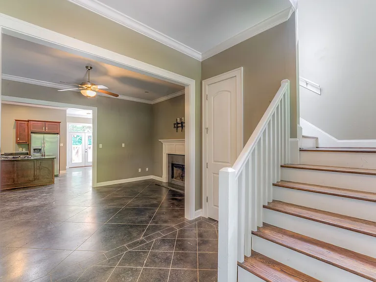 Living room with fireplace and foyer.