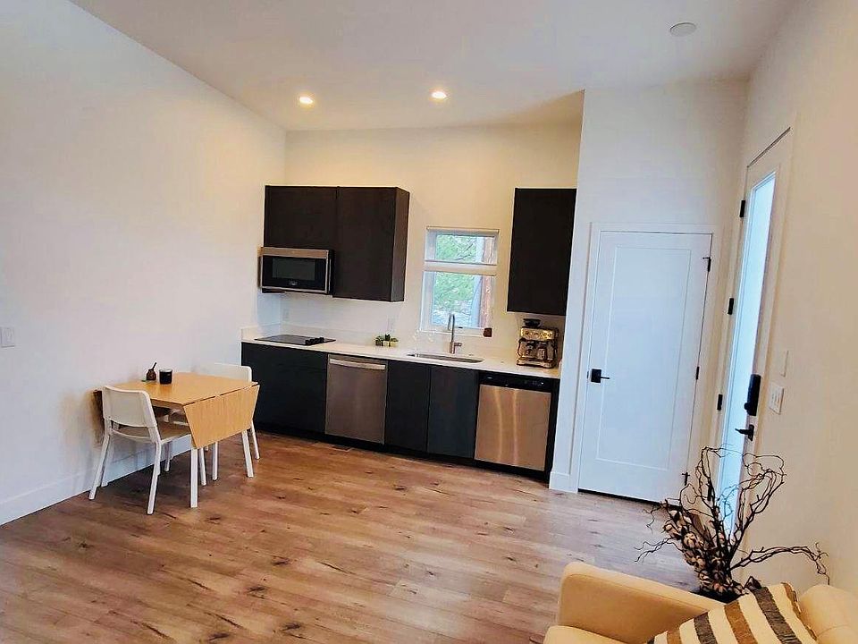 Entryway/living room/kitchen. Microwave is oven/microwave, induction cooktop, dishwasher, and under counter refrigerator. Large refrigerator freezer can be located in unit, or if you'd like more space can be in common detached garage/ gym.