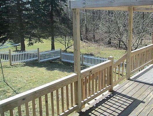 Back deck overlooking fenced in yard