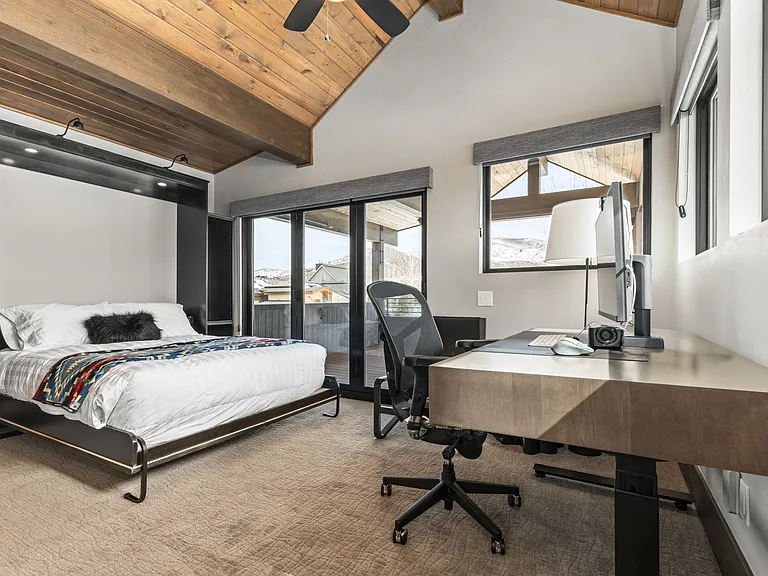 Upper Level Ensuite Bedroom 4 _ Currently set up as an office with a Queen Murphy Bed & Private Deck