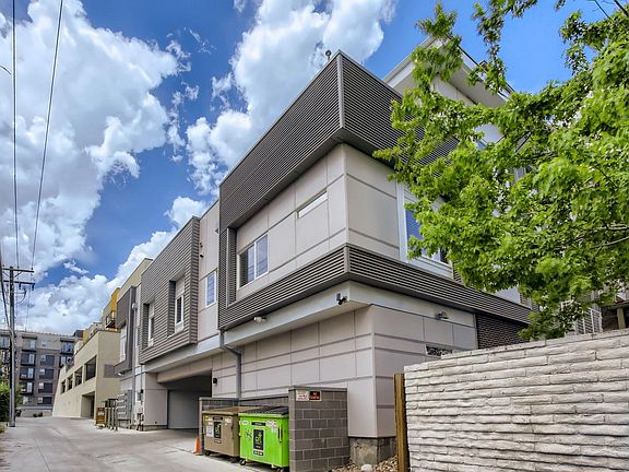 Exterior alley- garage entrance left of dumpsters