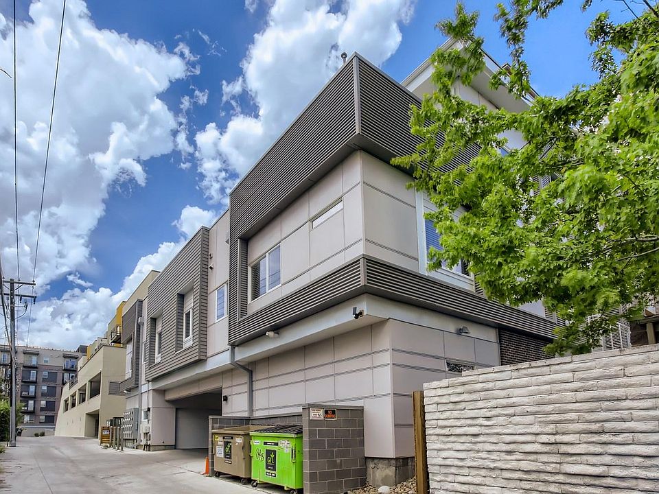 Exterior alley- garage entrance left of dumpsters