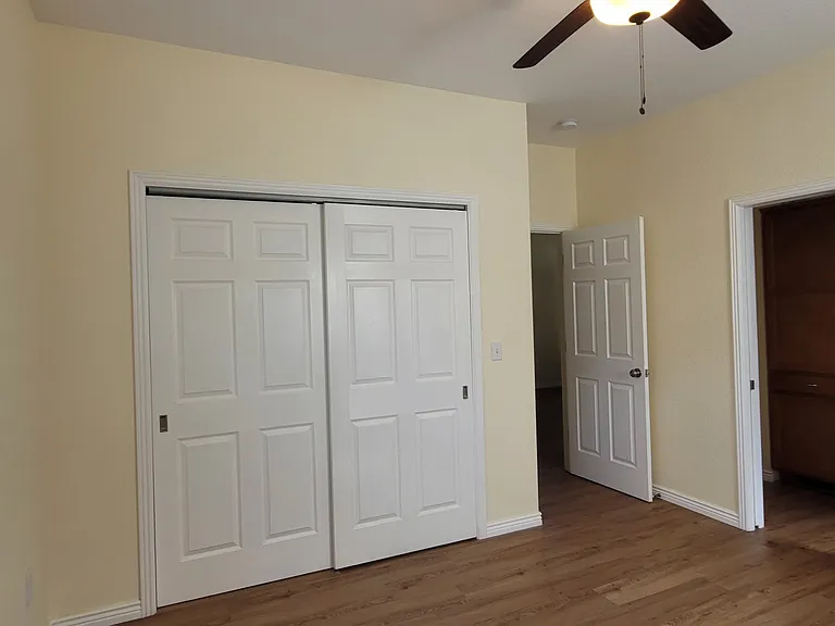 Master Bedroom with sliding closet doors closed and pocket door into the bathroom open.