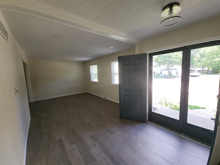 Front door entryway and living room. leads to dining room (left side of the picture toward the back wall), entry to the Kitchen (left side of the picture lower left hand side) and Stairway (behind the point of where picture was taken)