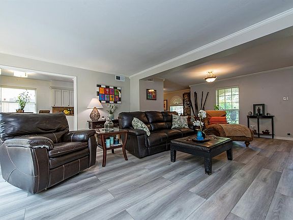 Spacious open plan living area. Gray toned flooring thoughout.